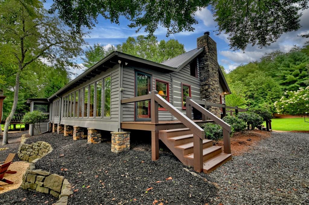 aerial view of a house with a yard balcony and furniture