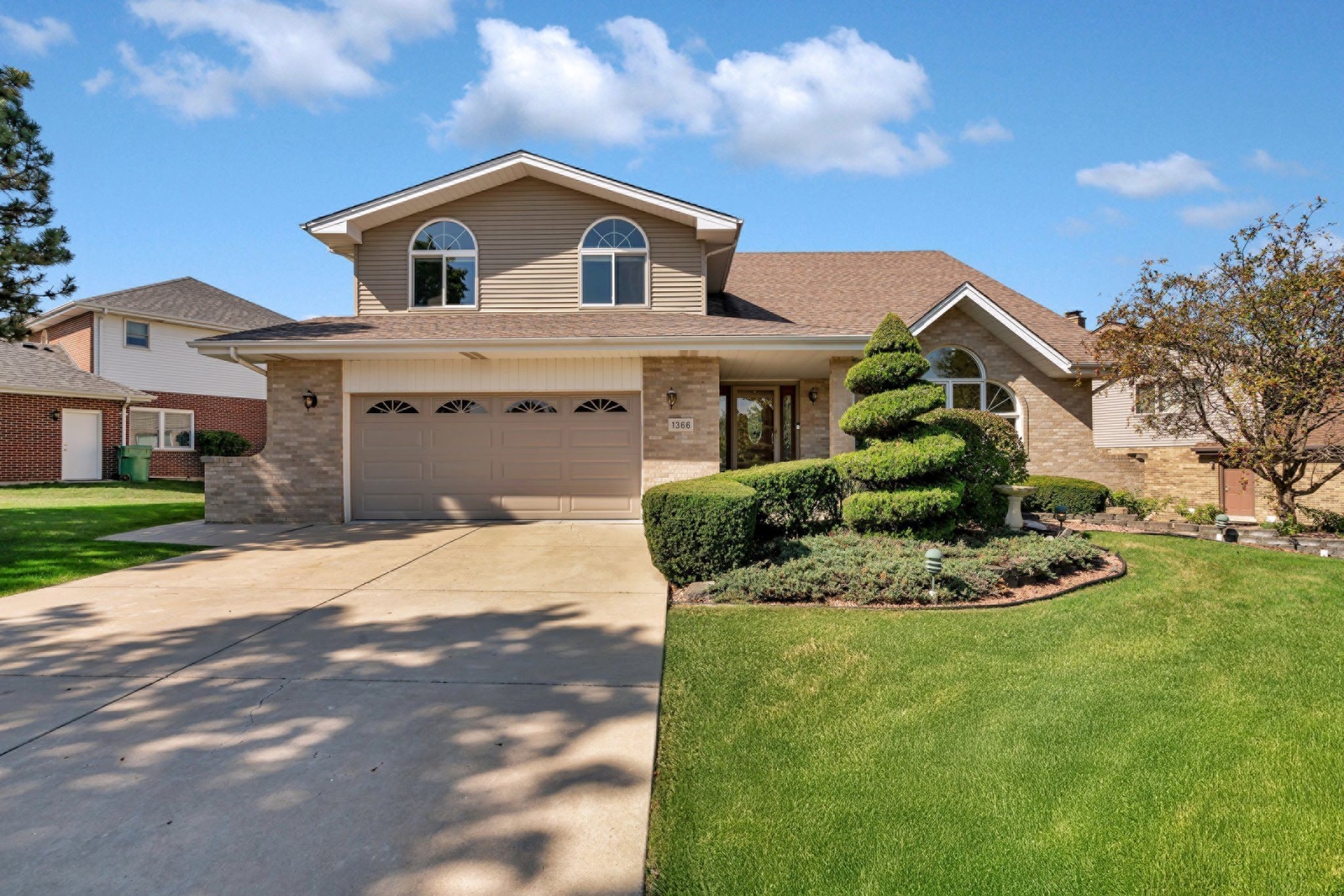 a front view of a house with a yard and garage