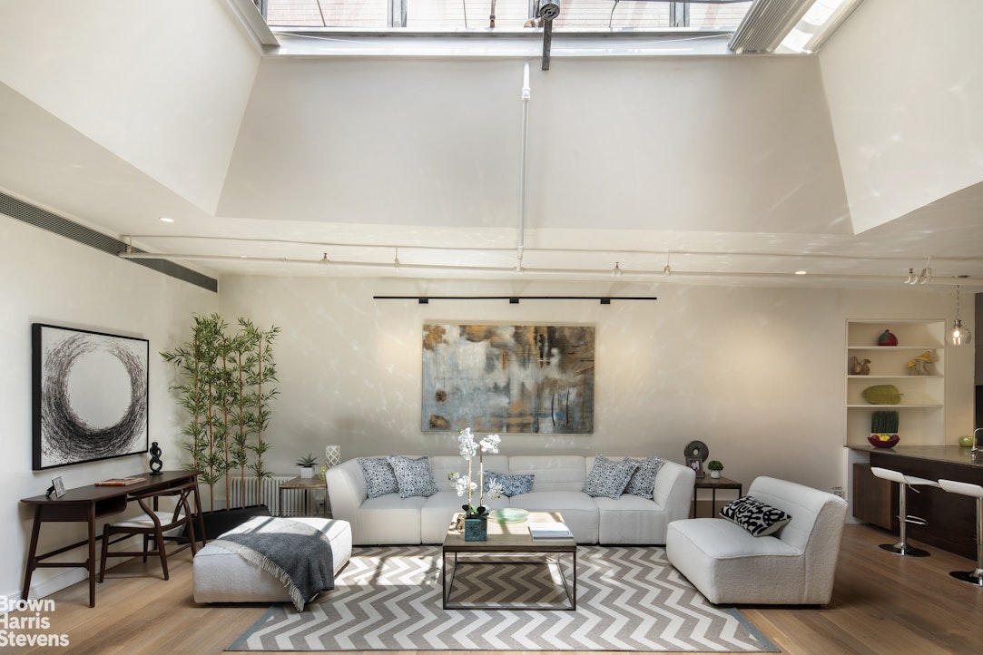 a living room with furniture and a potted plant