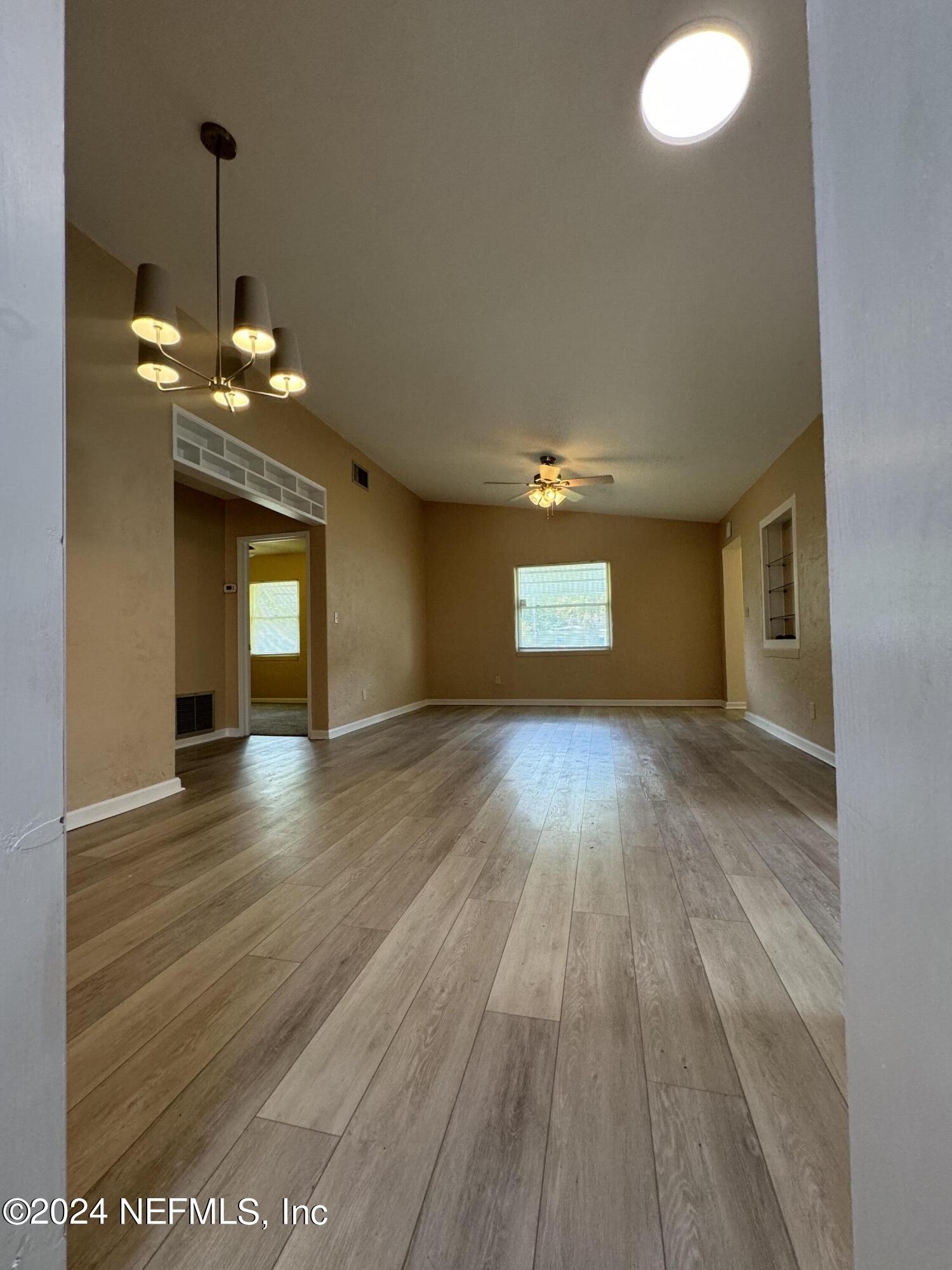 a view of a livingroom with wooden floor