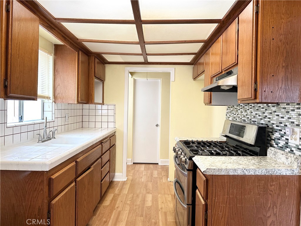 a kitchen with a sink stove and cabinets