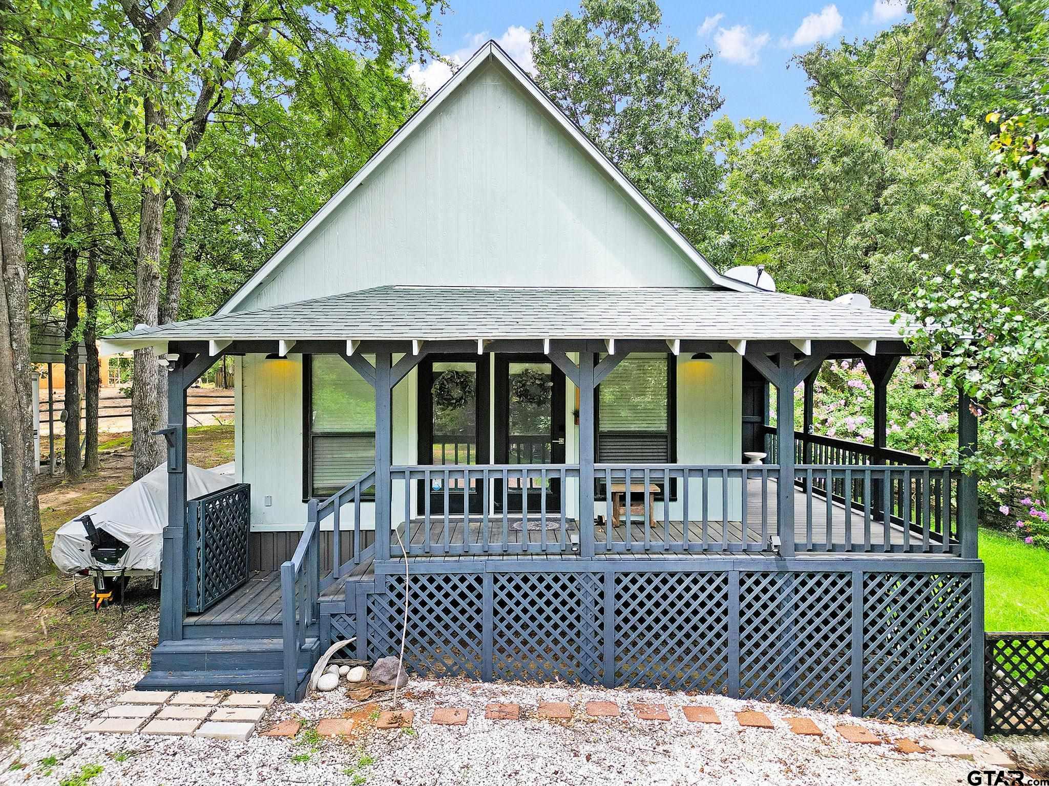 a view of a house with a wooden deck