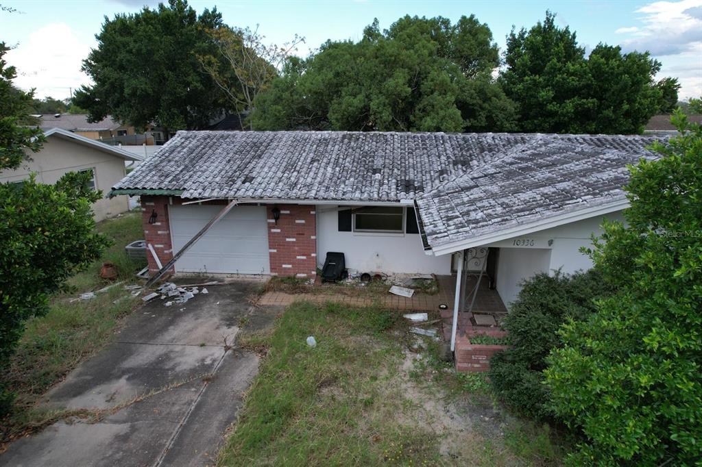 an aerial view of a house with a yard