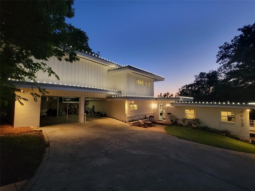 a view of a house with entertaining space and a car parked in it