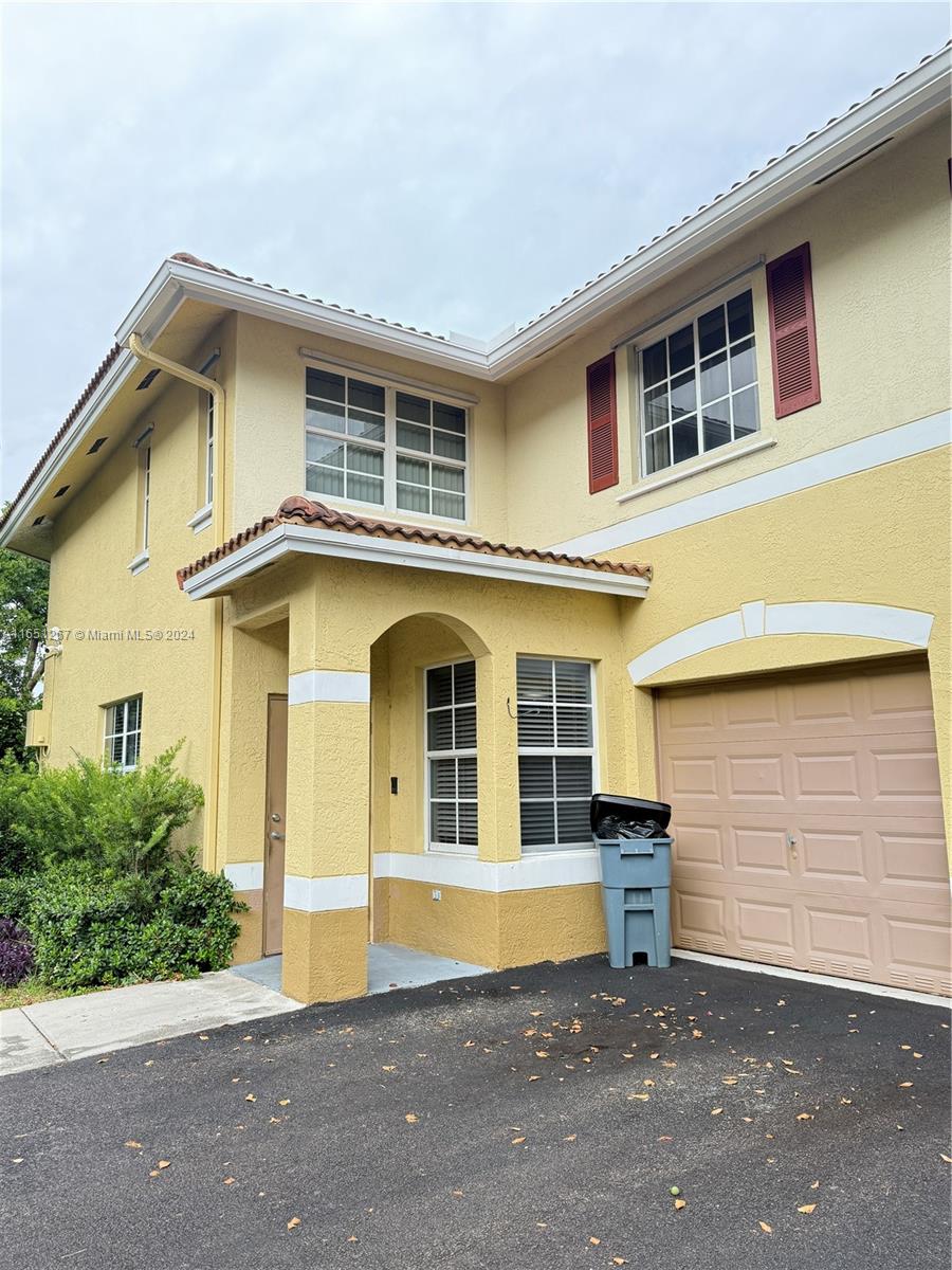 a front view of a house with garage