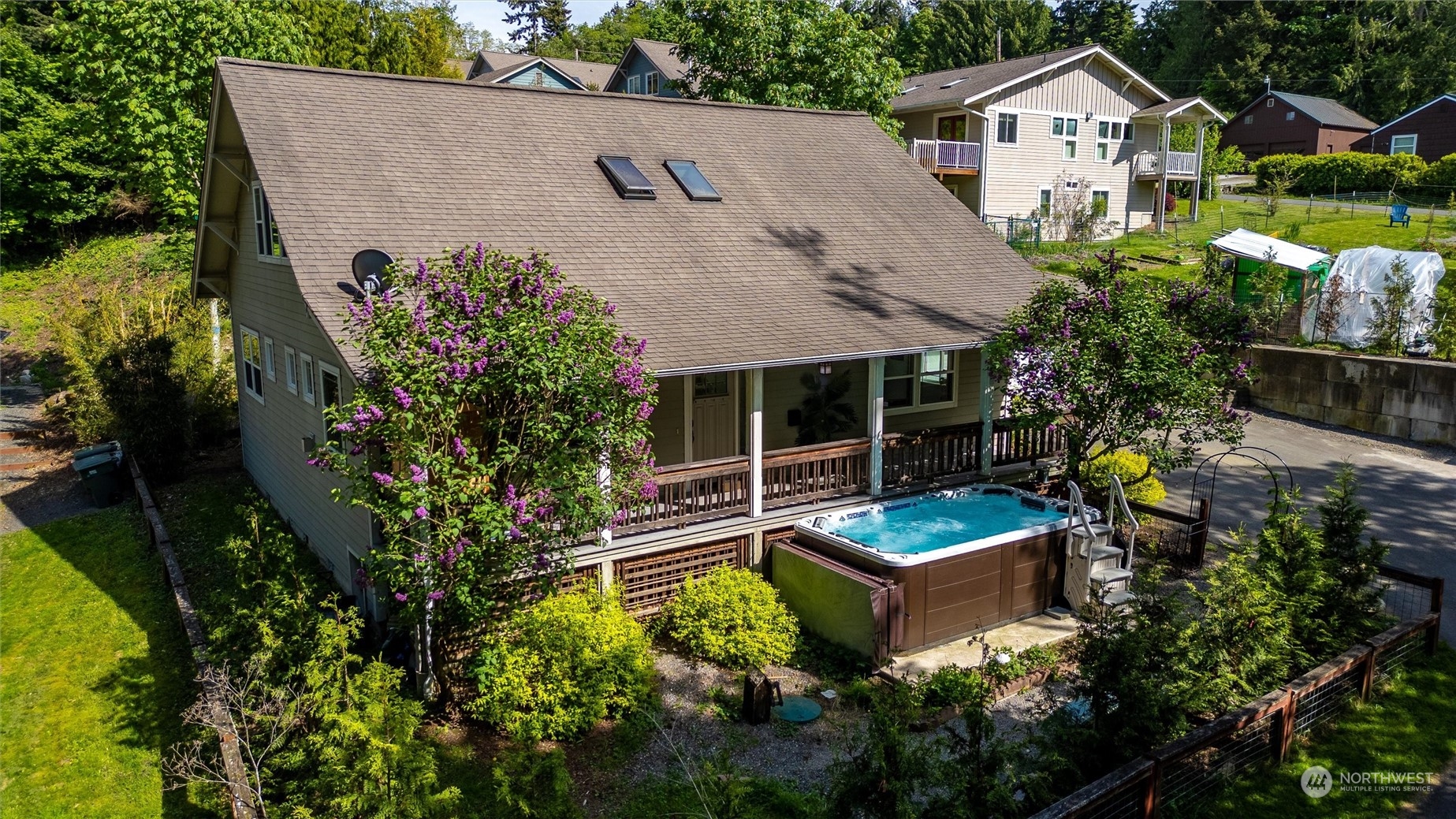 an aerial view of a house with garden space and sitting area