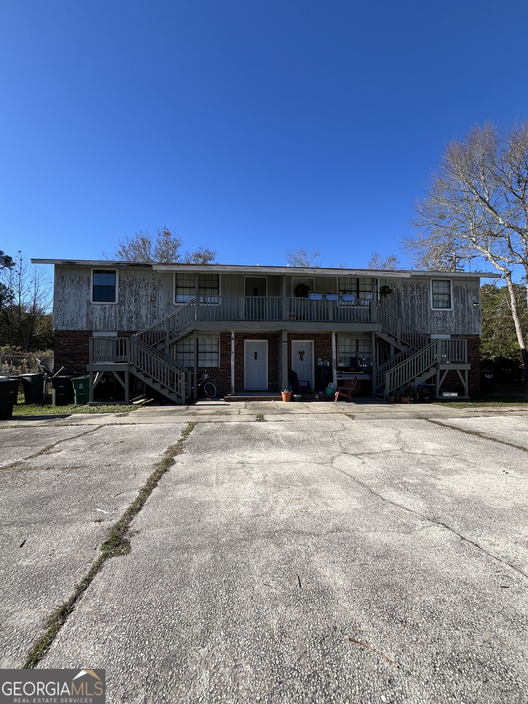 a view of a house with a yard and parking space