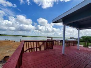 a view of roof deck with a table and chairs