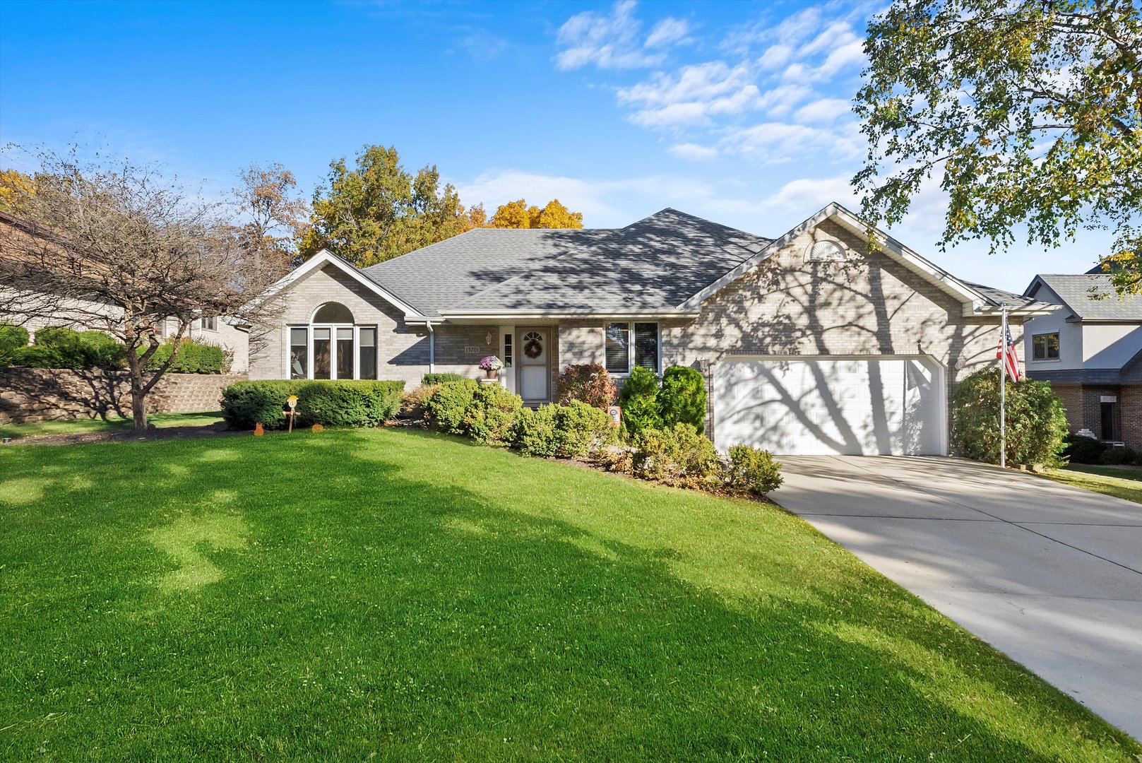 a front view of a house with a garden and plants