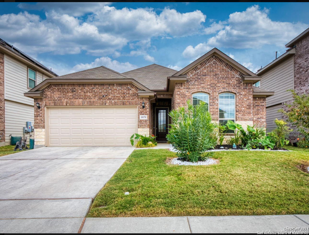 a front view of a house with a yard