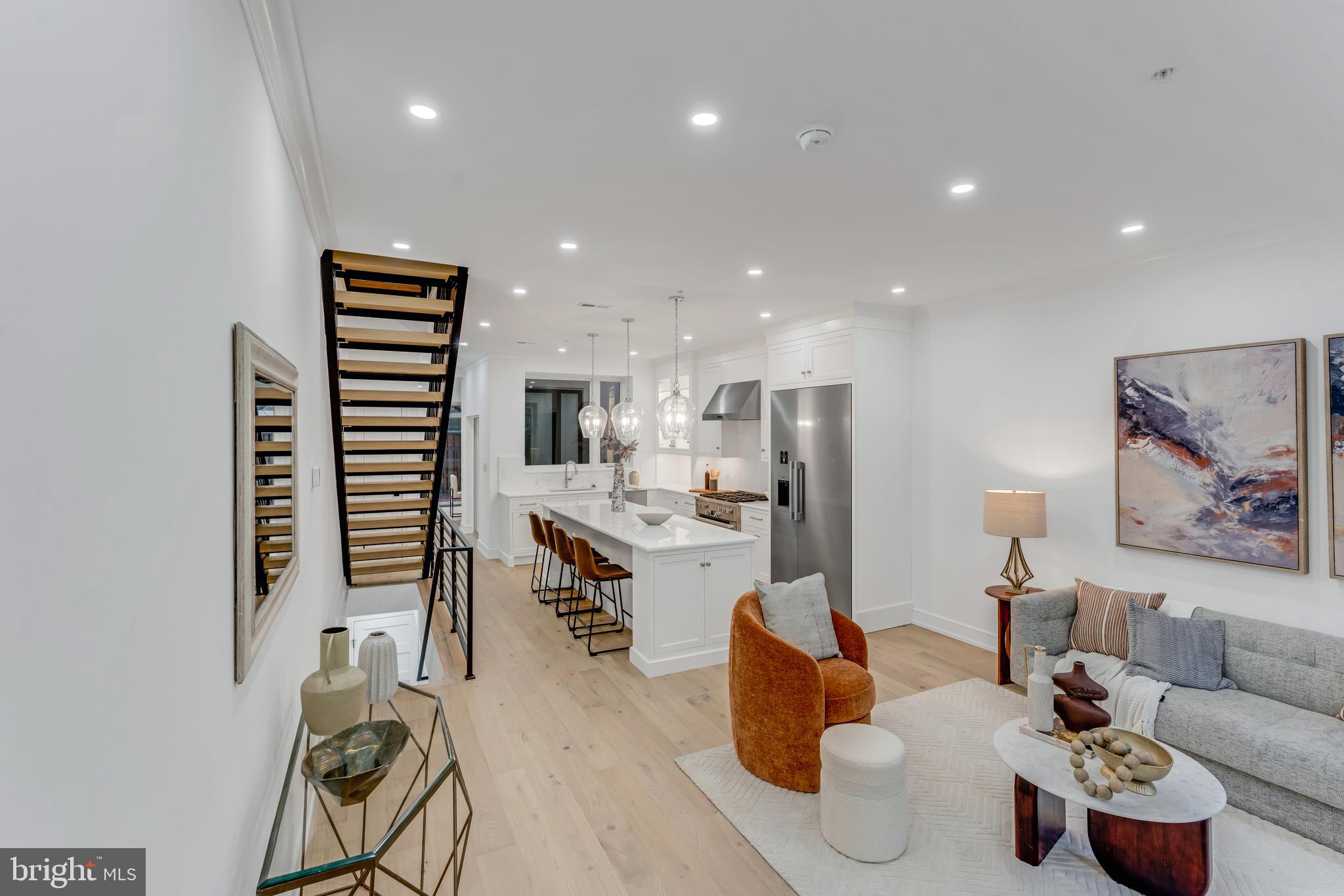 a living room with furniture kitchen and a table