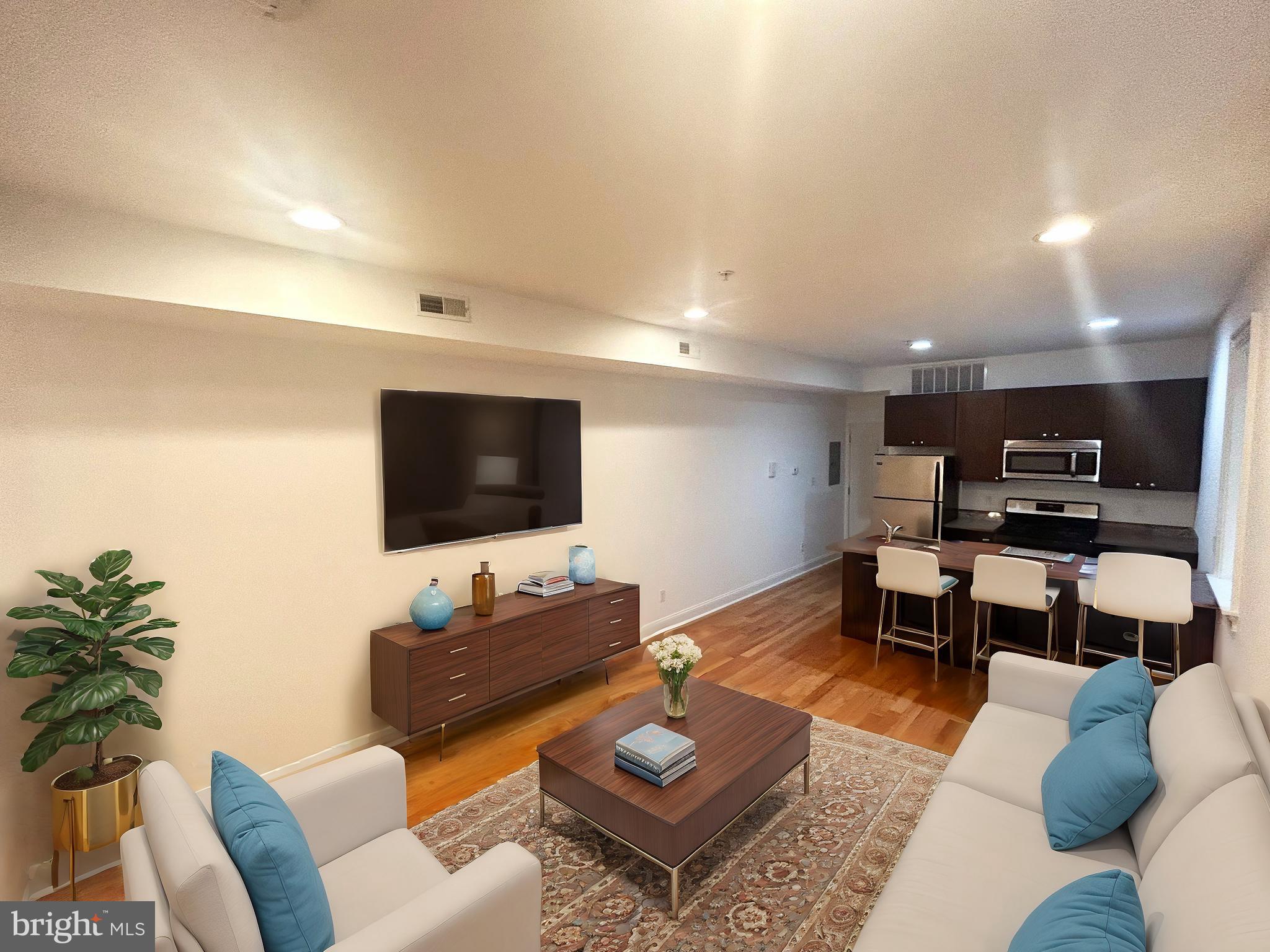 a living room with furniture and a flat screen tv