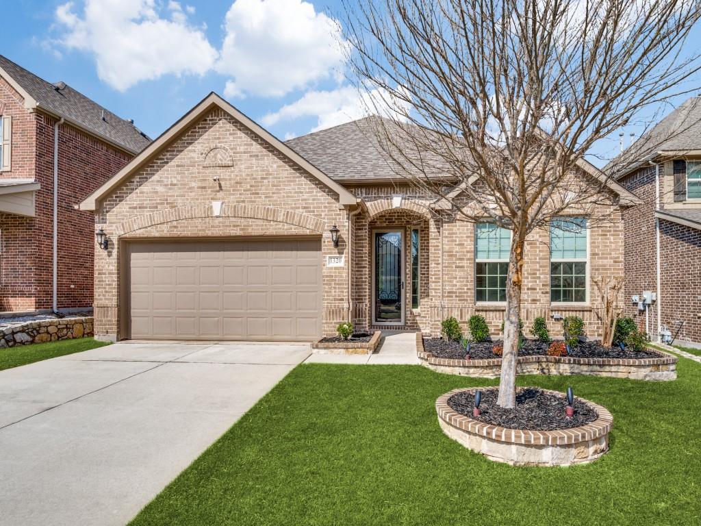 a front view of a house with a yard garage and fountain