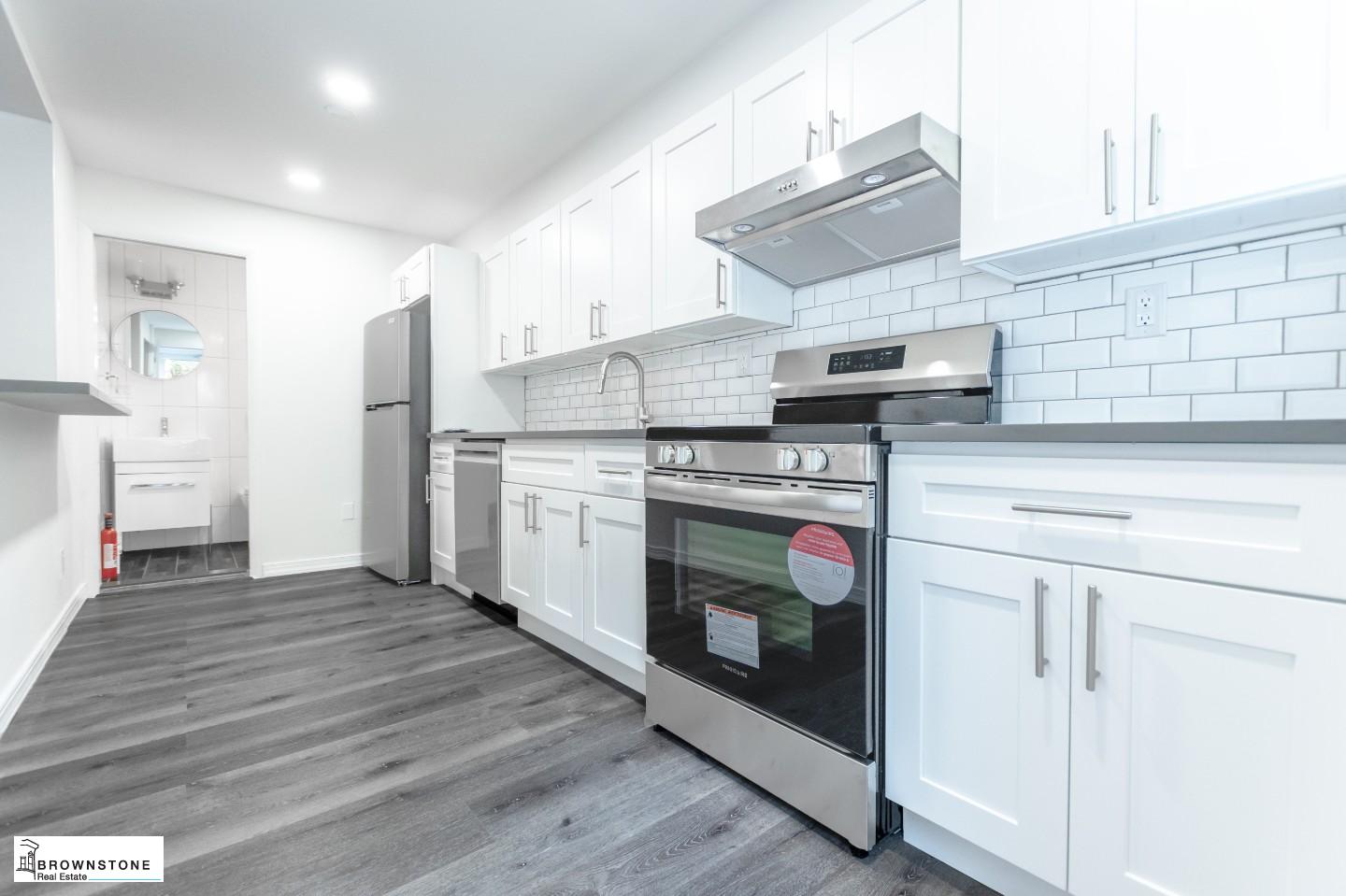 a kitchen with stainless steel appliances granite countertop a stove and a refrigerator