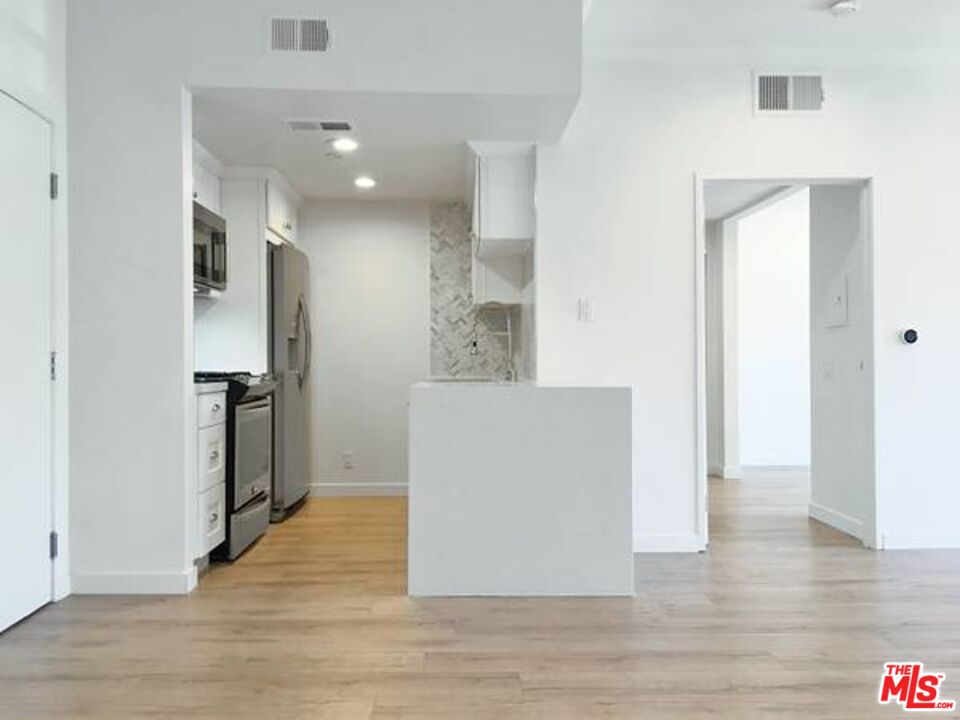 a view of a kitchen cabinets and wooden floor