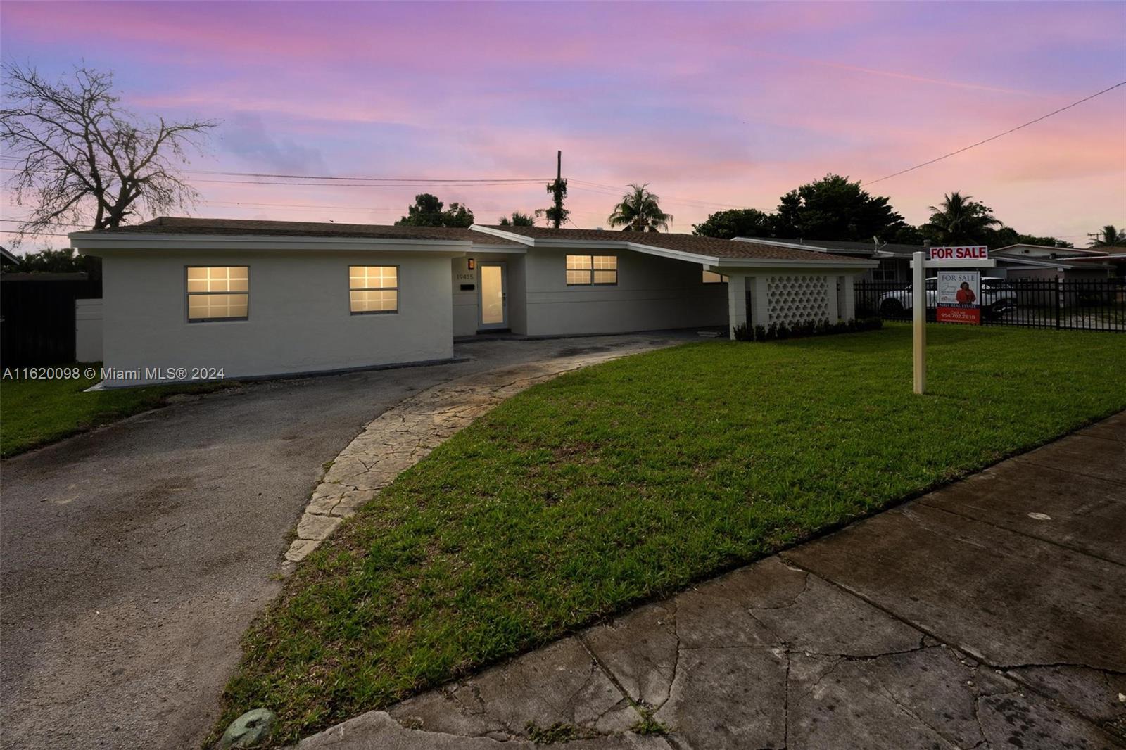 a front view of a house with a yard and a garage