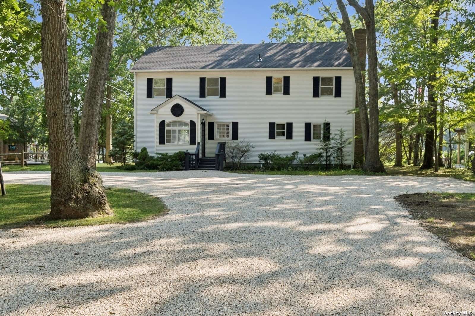 a view of a white house with a yard