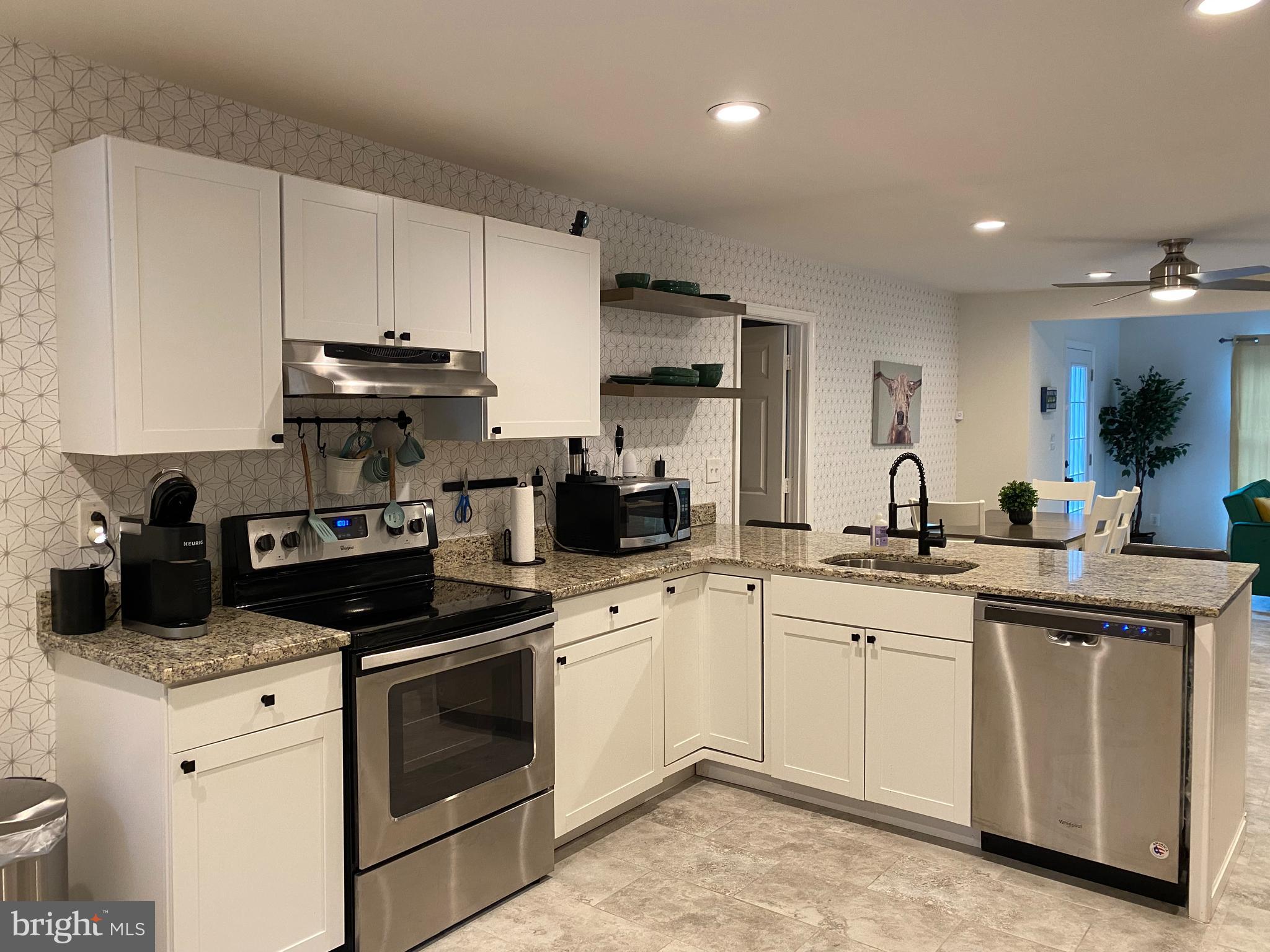 a kitchen with a sink stove and cabinets