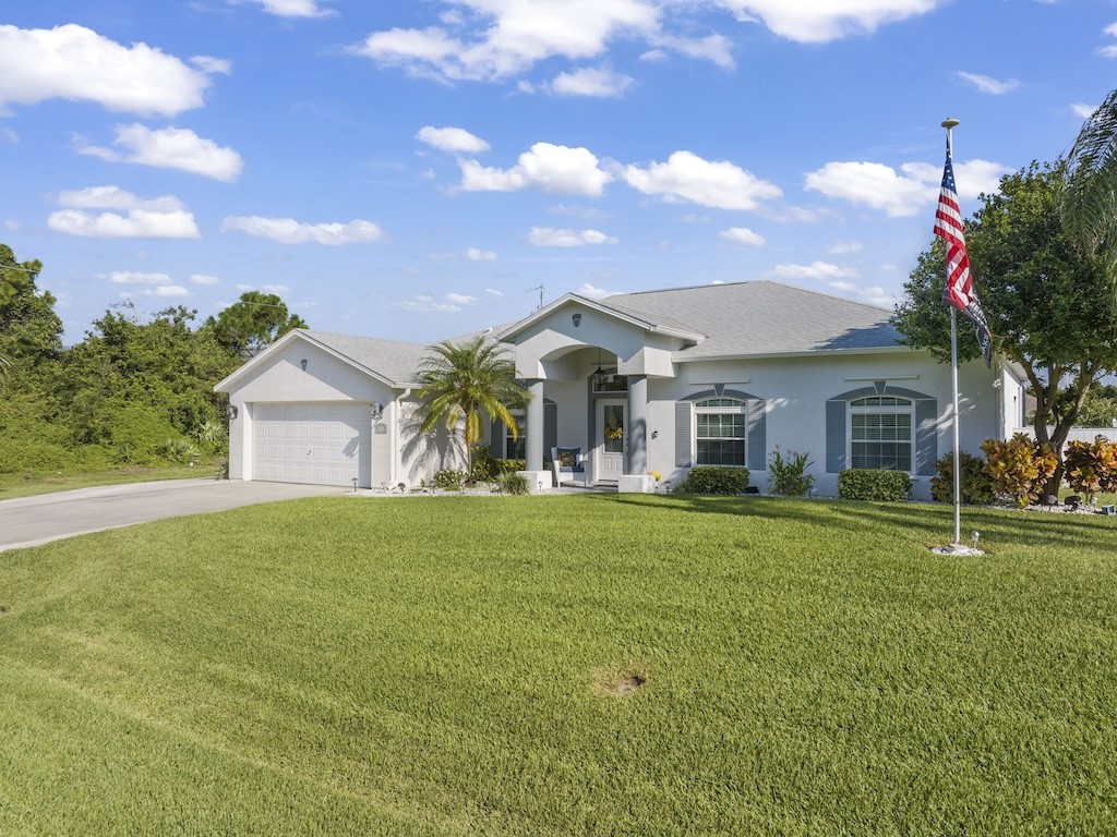 a front view of a house with a garden