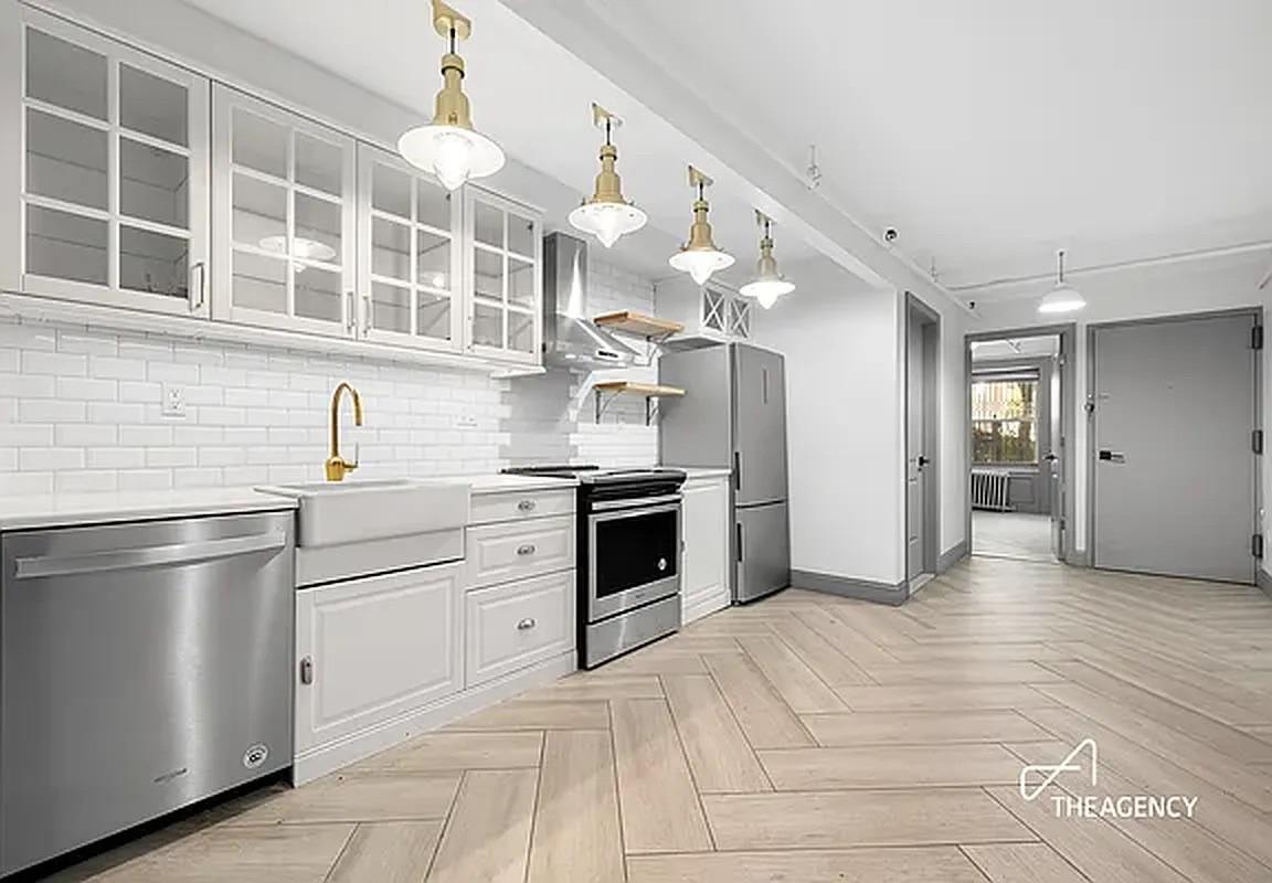 a kitchen with stainless steel appliances granite countertop a refrigerator and a sink