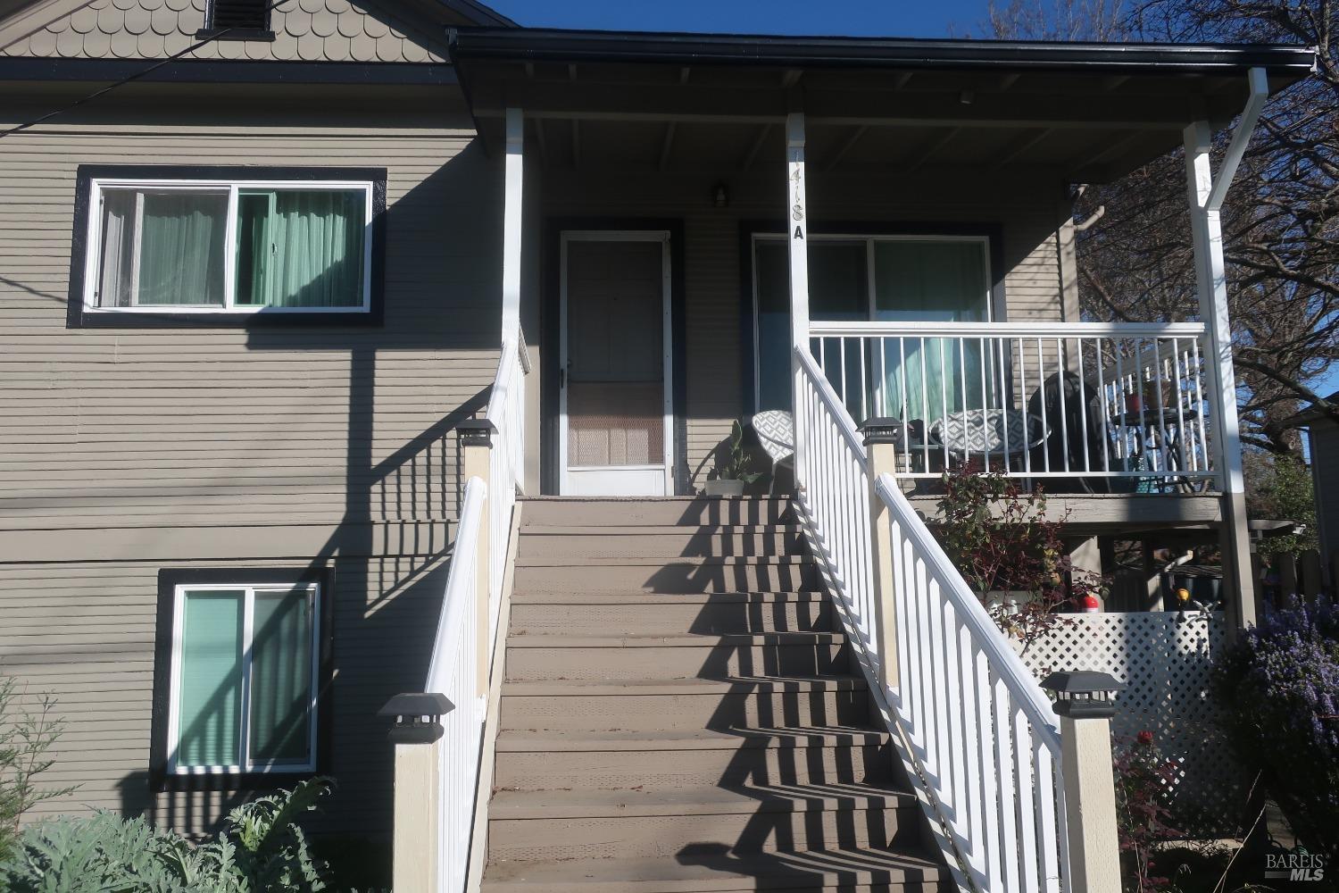 a view of balcony with wooden floor and stairs