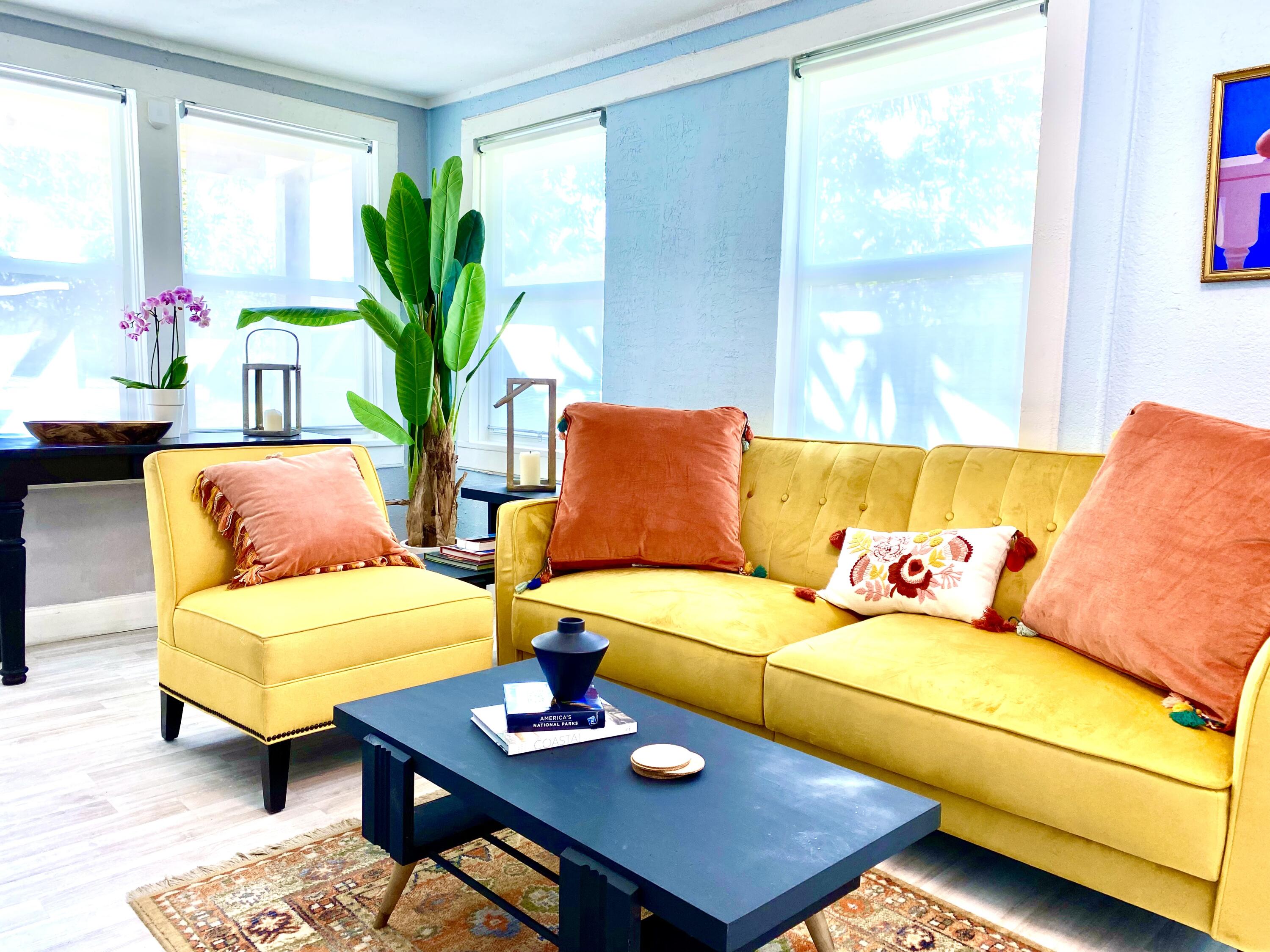 a living room with furniture and a potted plant