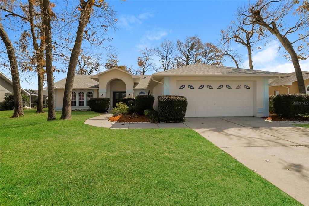 a view of a house with a backyard