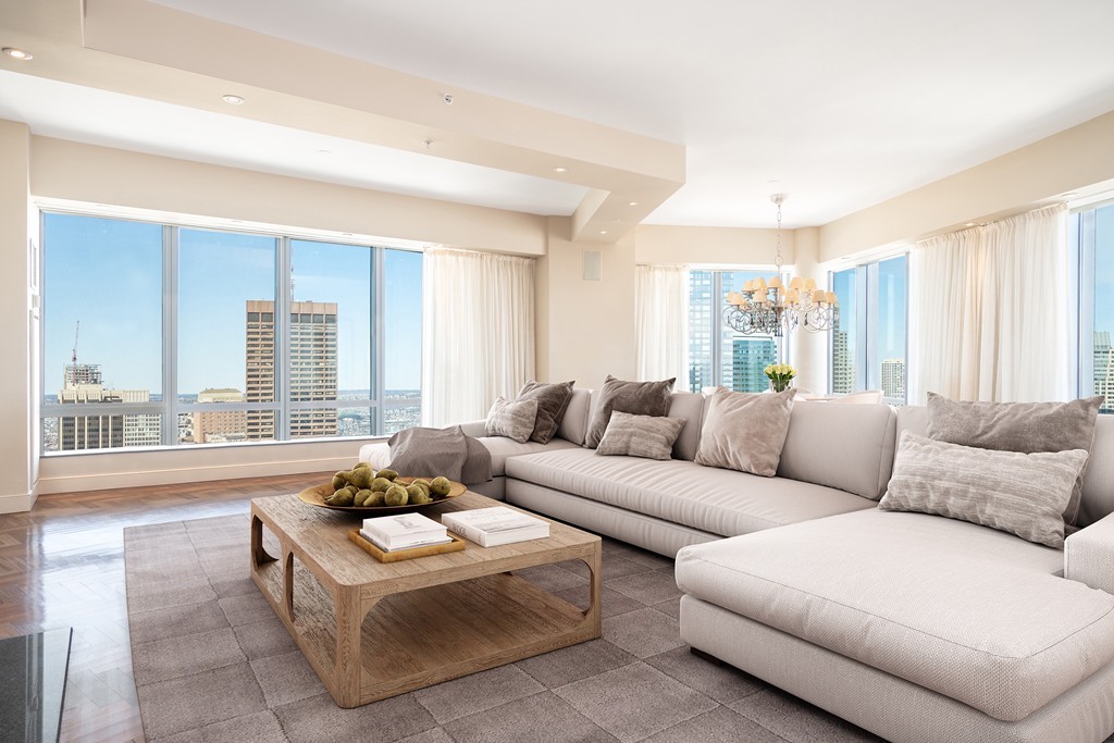 a living room with furniture and large windows