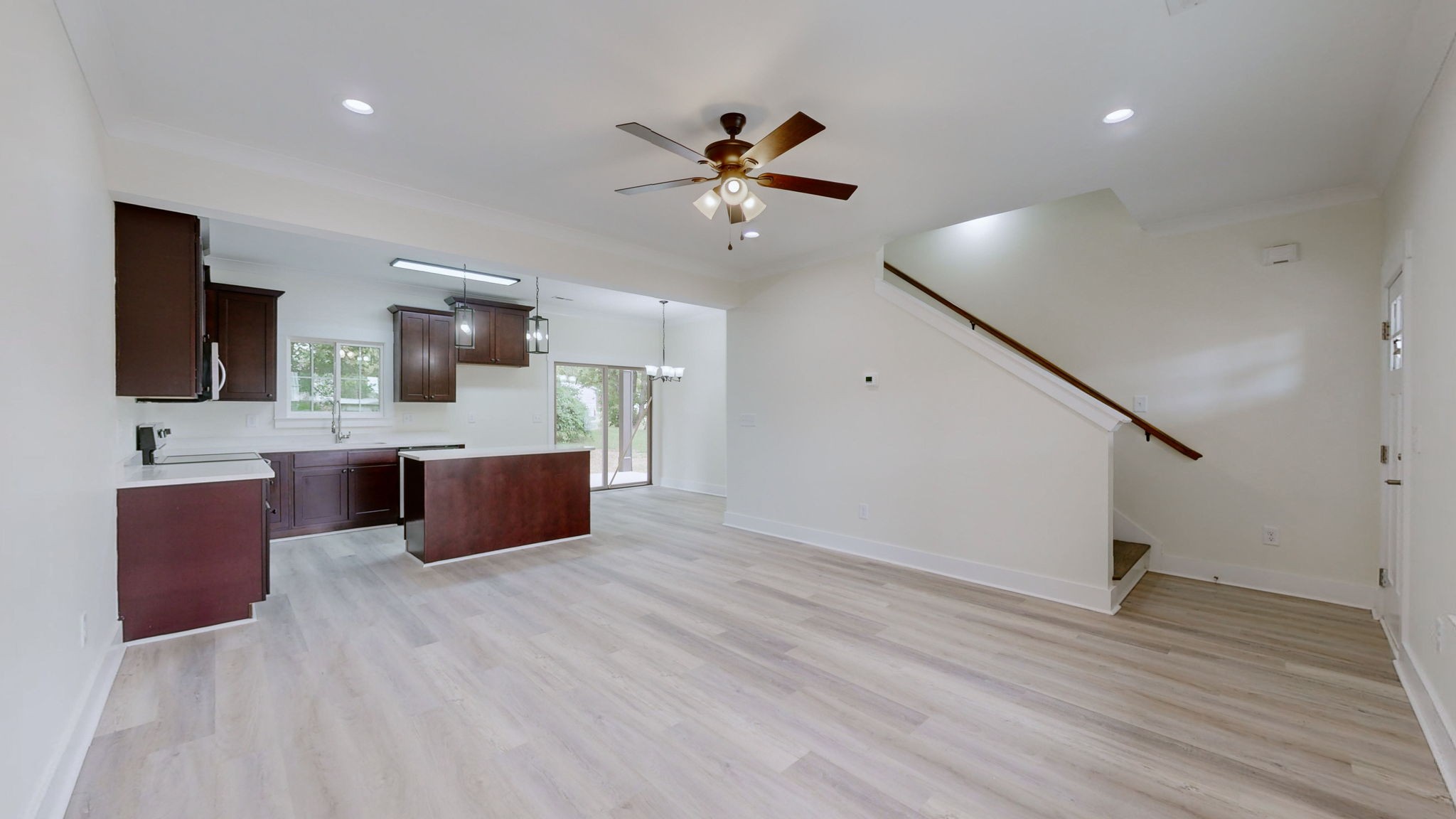 a large room with a lot of cabinets and wooden floor