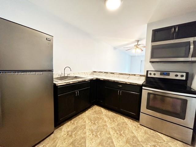 a kitchen with a sink and a refrigerator