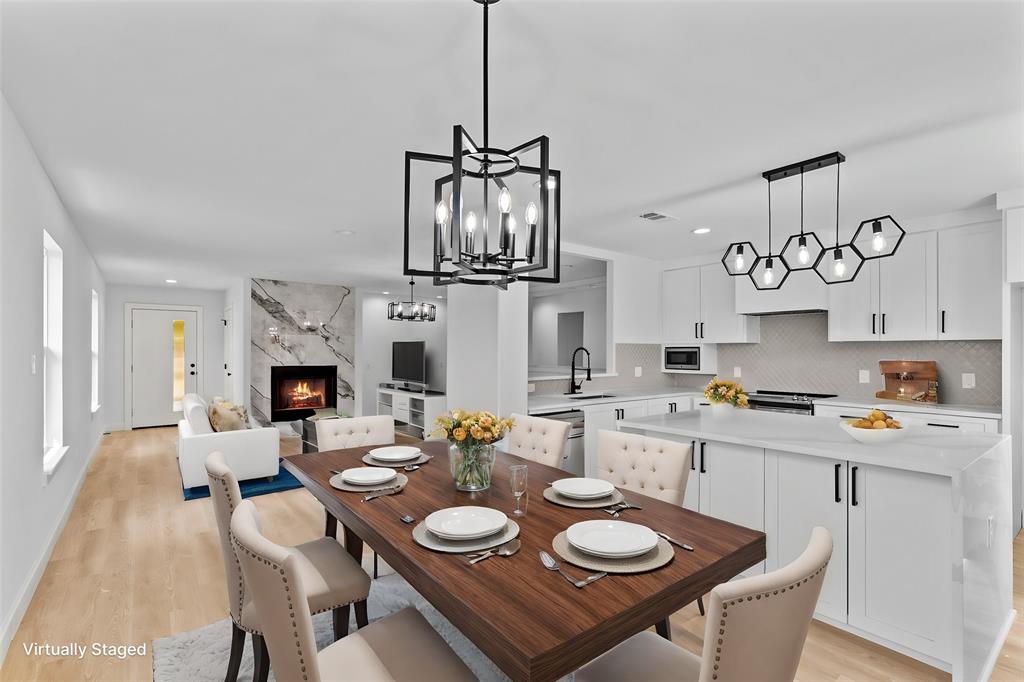 a open dining room with furniture wooden floor and kitchen view