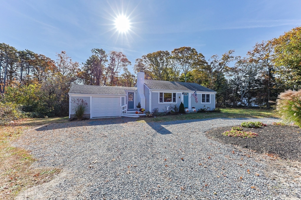 a front view of a house with a yard and a garage