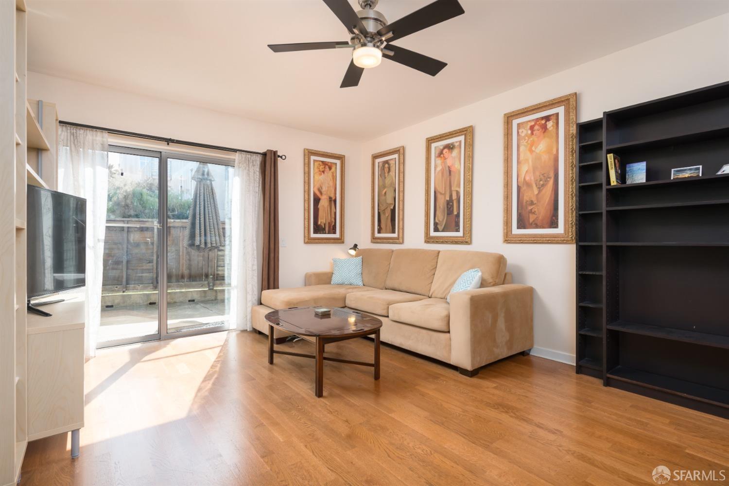 a living room with furniture and a floor to ceiling window