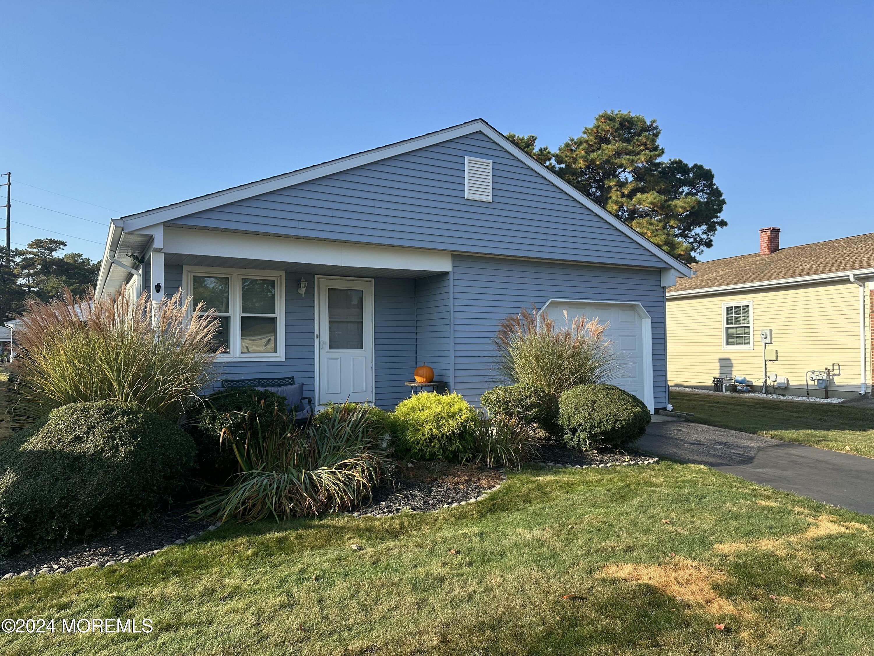 a front view of house with yard and green space