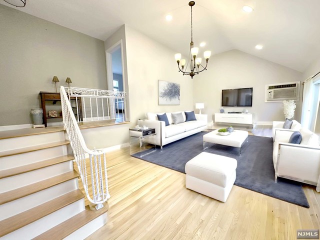 a living room with fireplace furniture and a flat screen tv