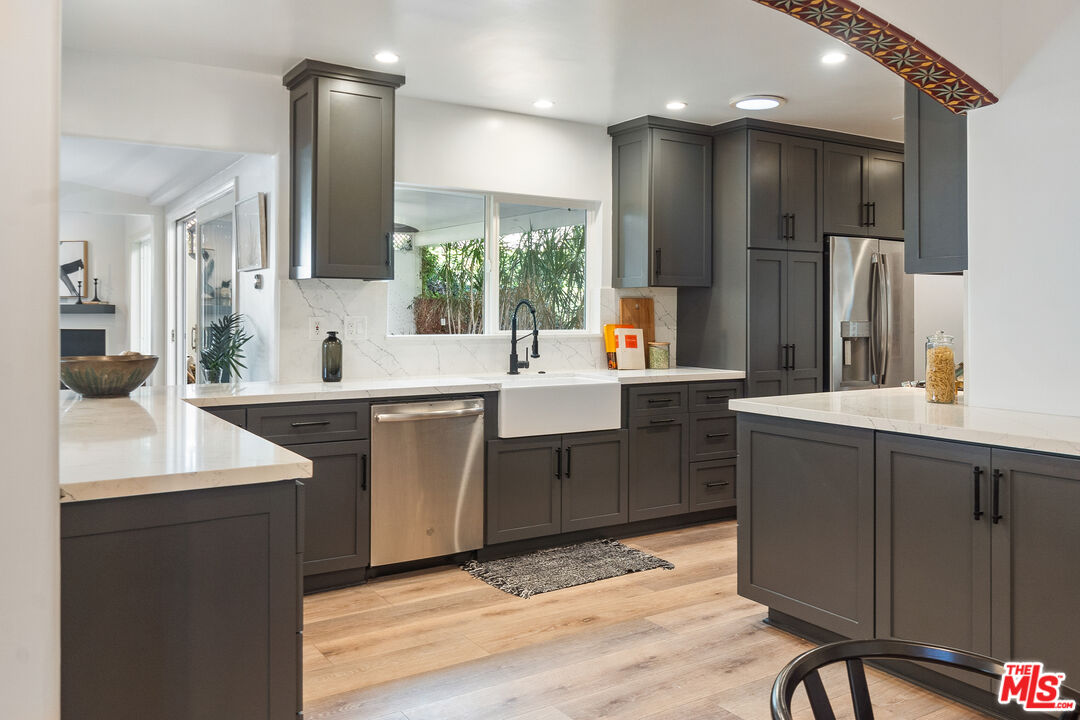 a kitchen with a sink appliances and cabinets