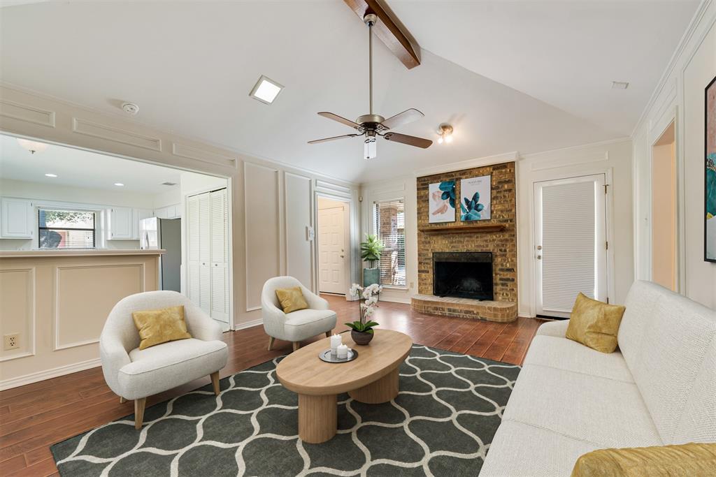 a living room with furniture a fireplace and a chandelier