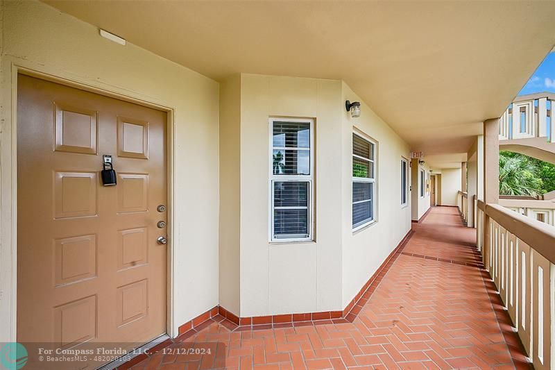 a view of a balcony with wooden floor and fence