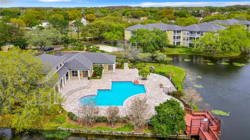 an aerial view of a house with garden space and lake view