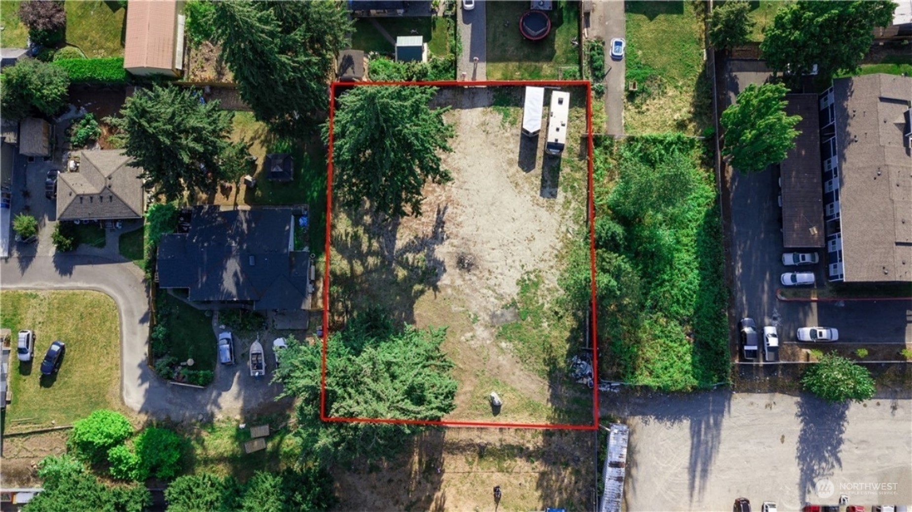 an aerial view of a house with plants and large trees