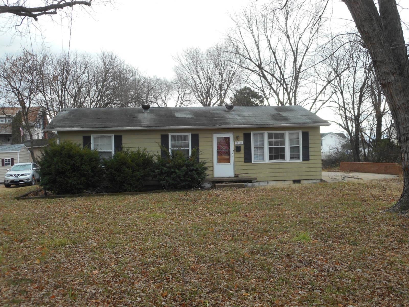 a view of a house with yard and tree s