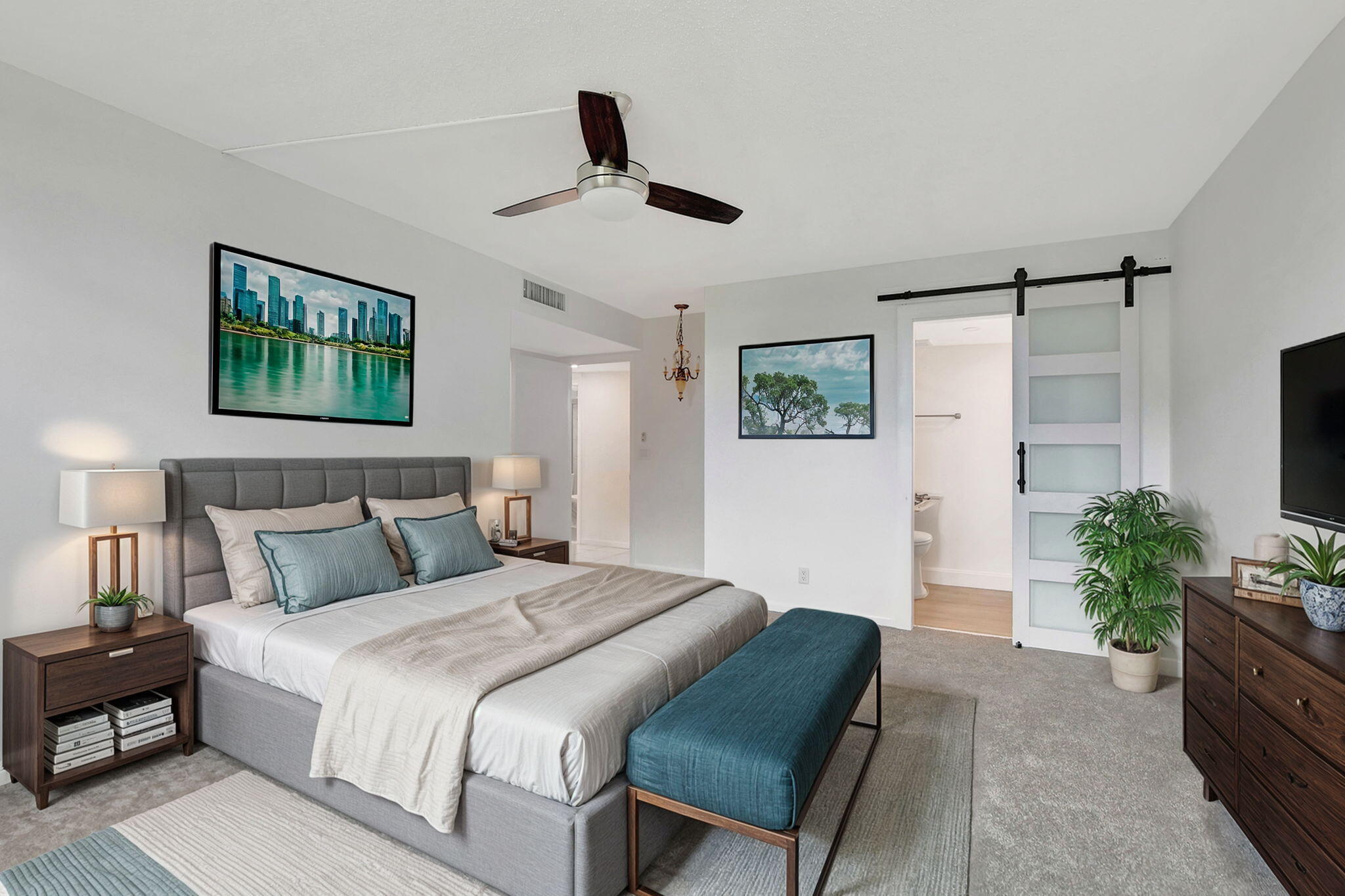 a bedroom with a large bed and a potted plant