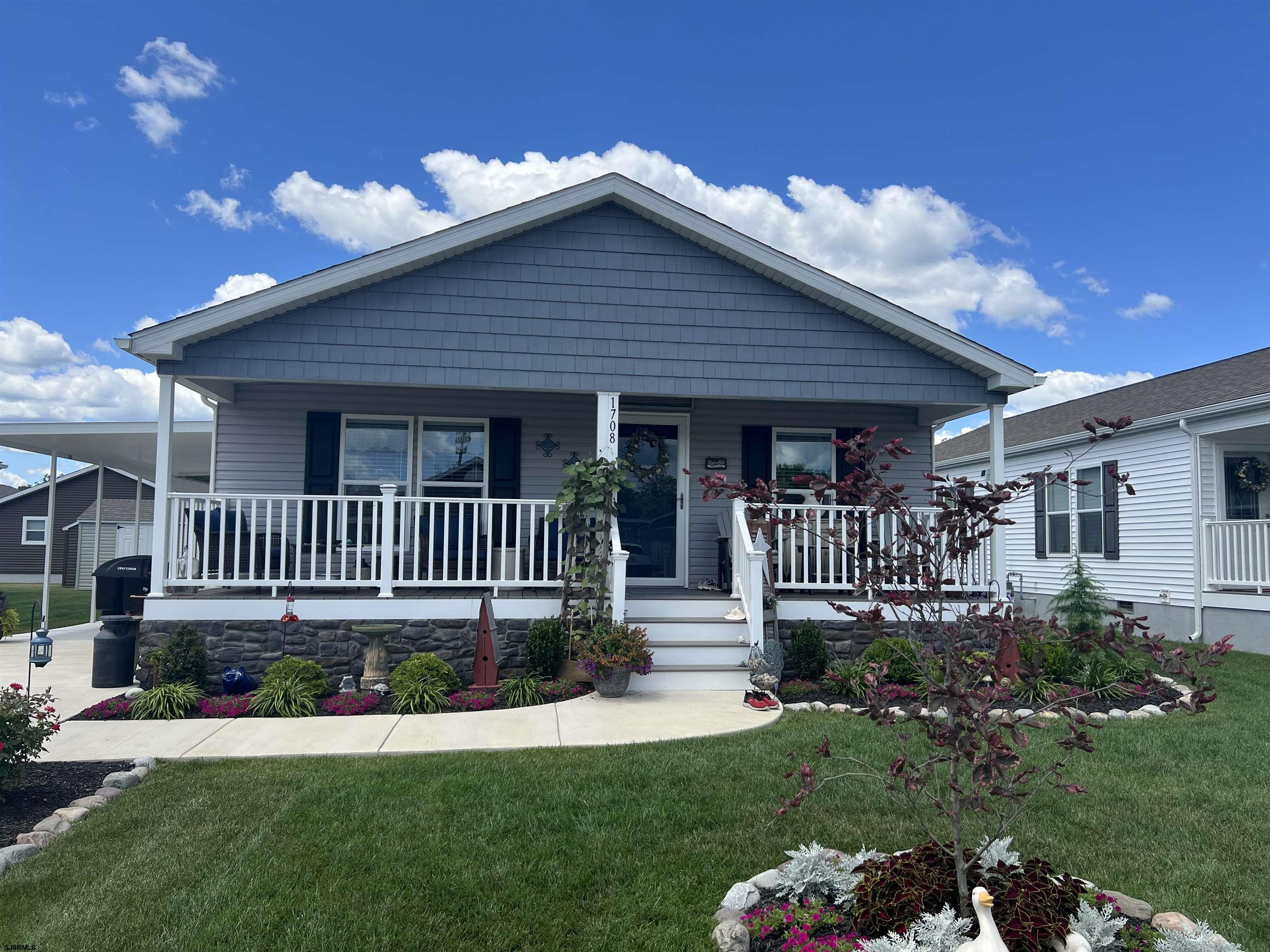 a view of a house with a yard and deck