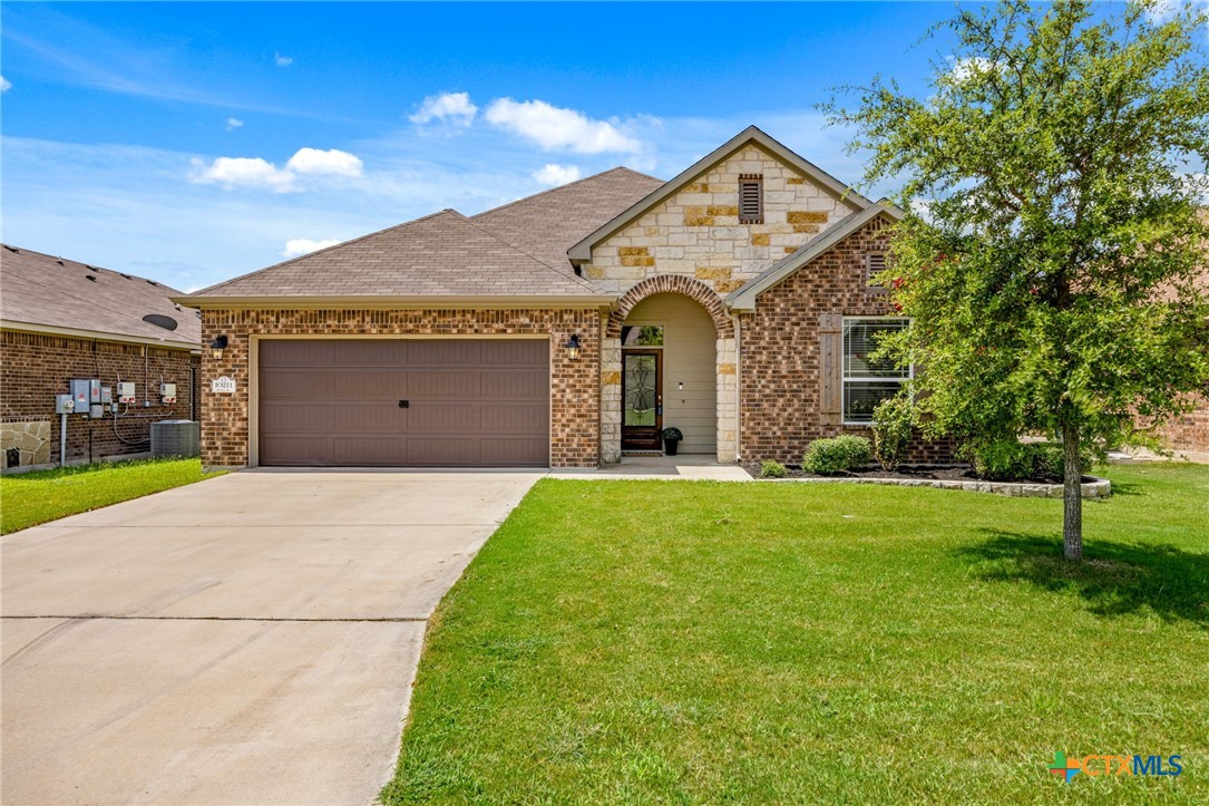 a front view of a house with a yard and garage