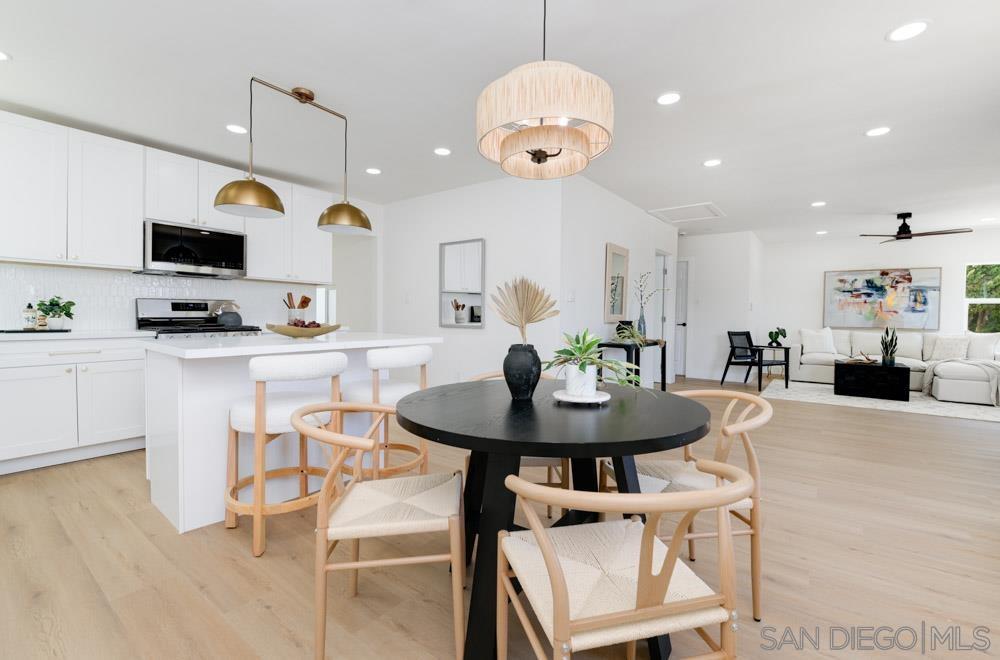 a large kitchen with a table and chairs