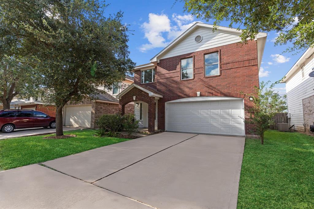 a front view of a house with a yard and garage