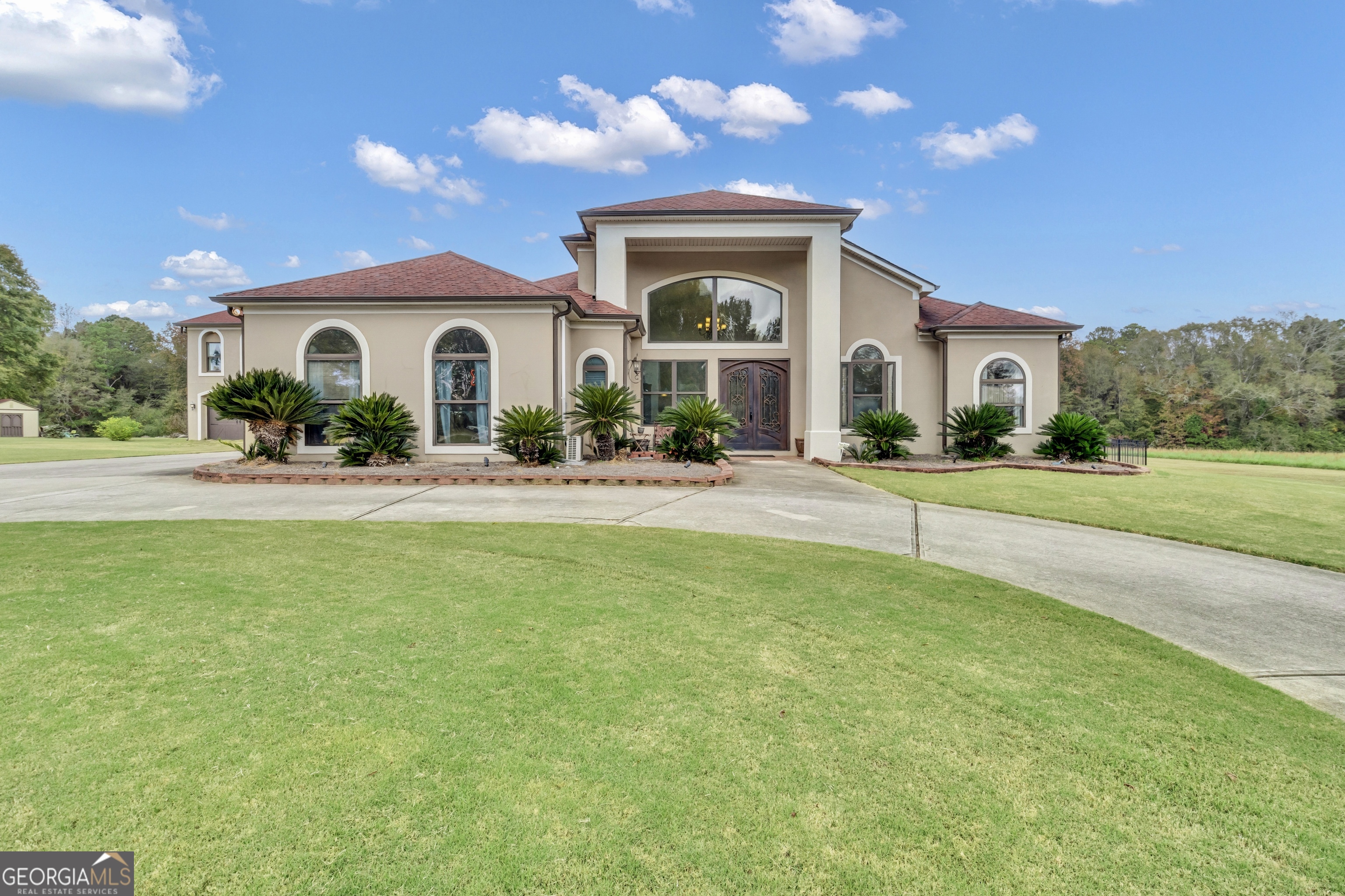 a front view of house with yard and green space