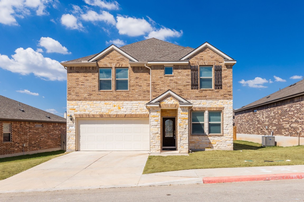 a front view of a house with a yard and garage