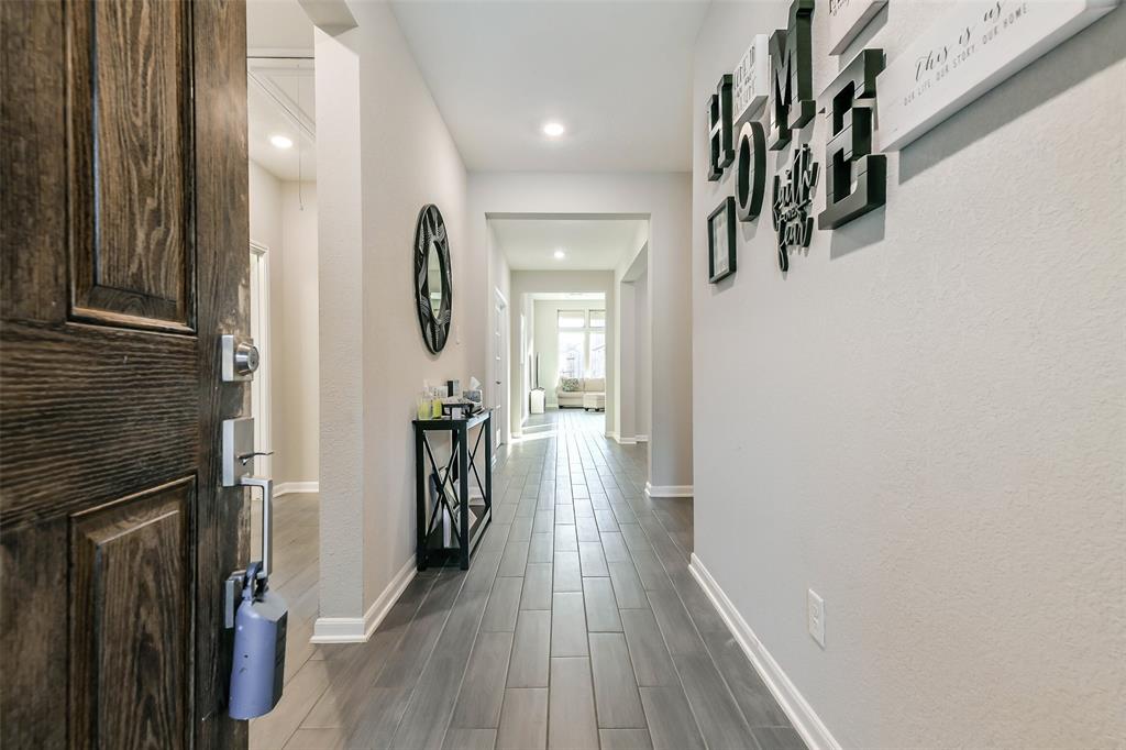 a view of hallway with wooden floor