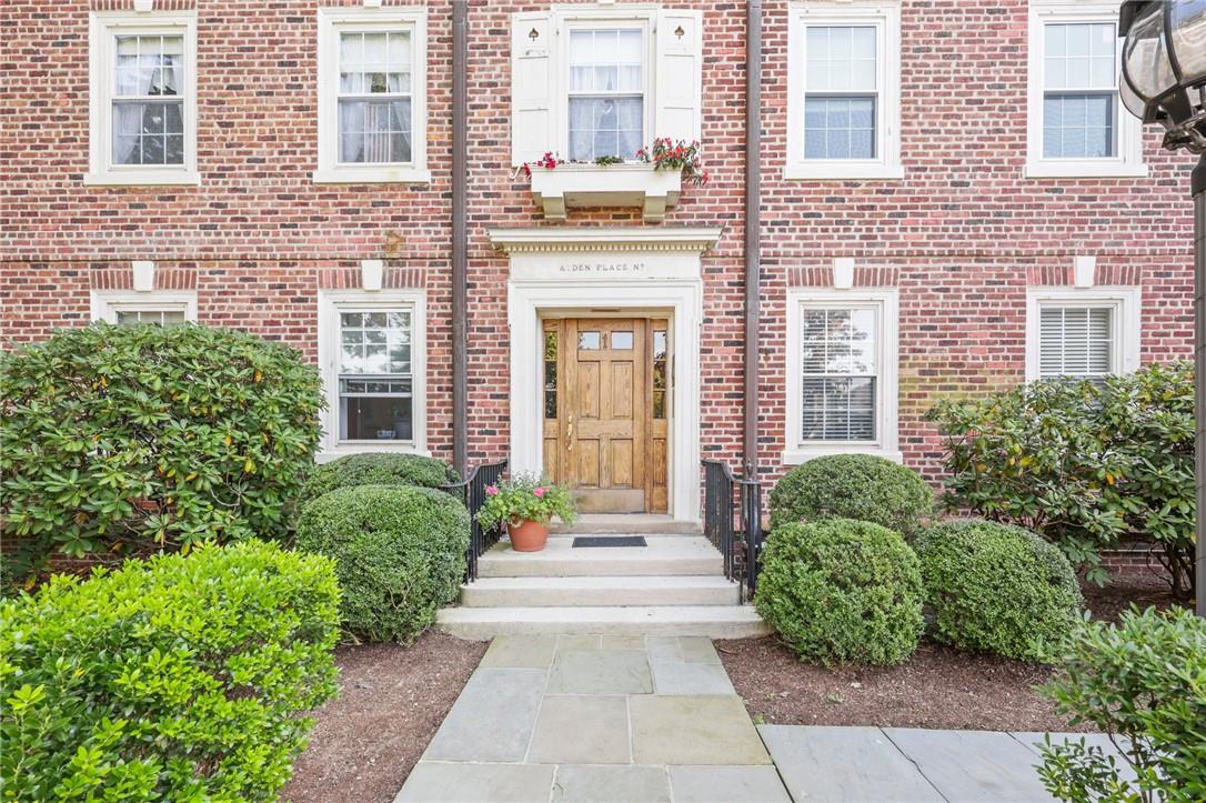 front view of a brick house with a large windows